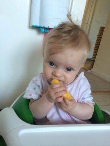 baby eating mango