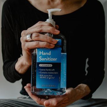 woman holding hand sanitiser