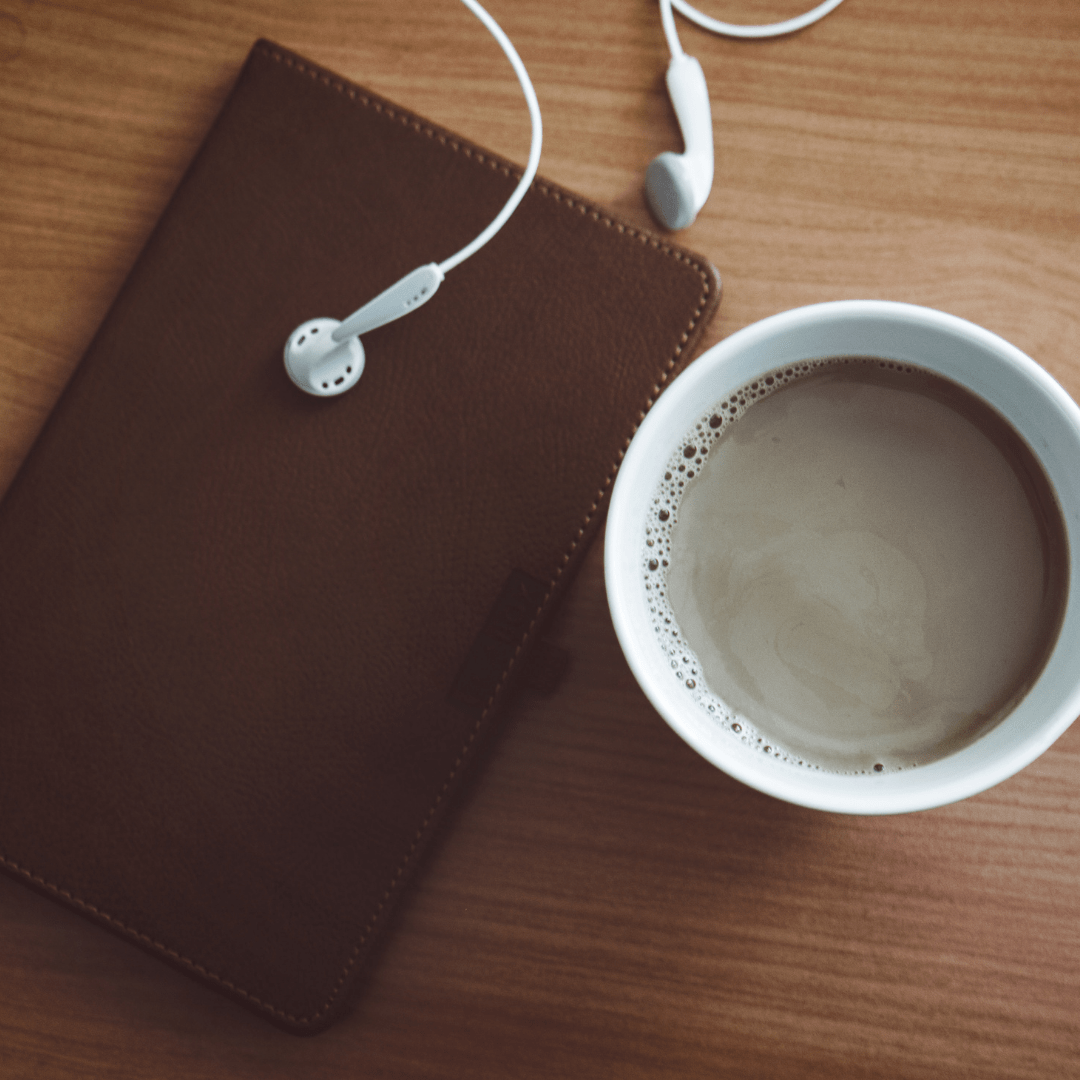 earbuds, coffee and notebook